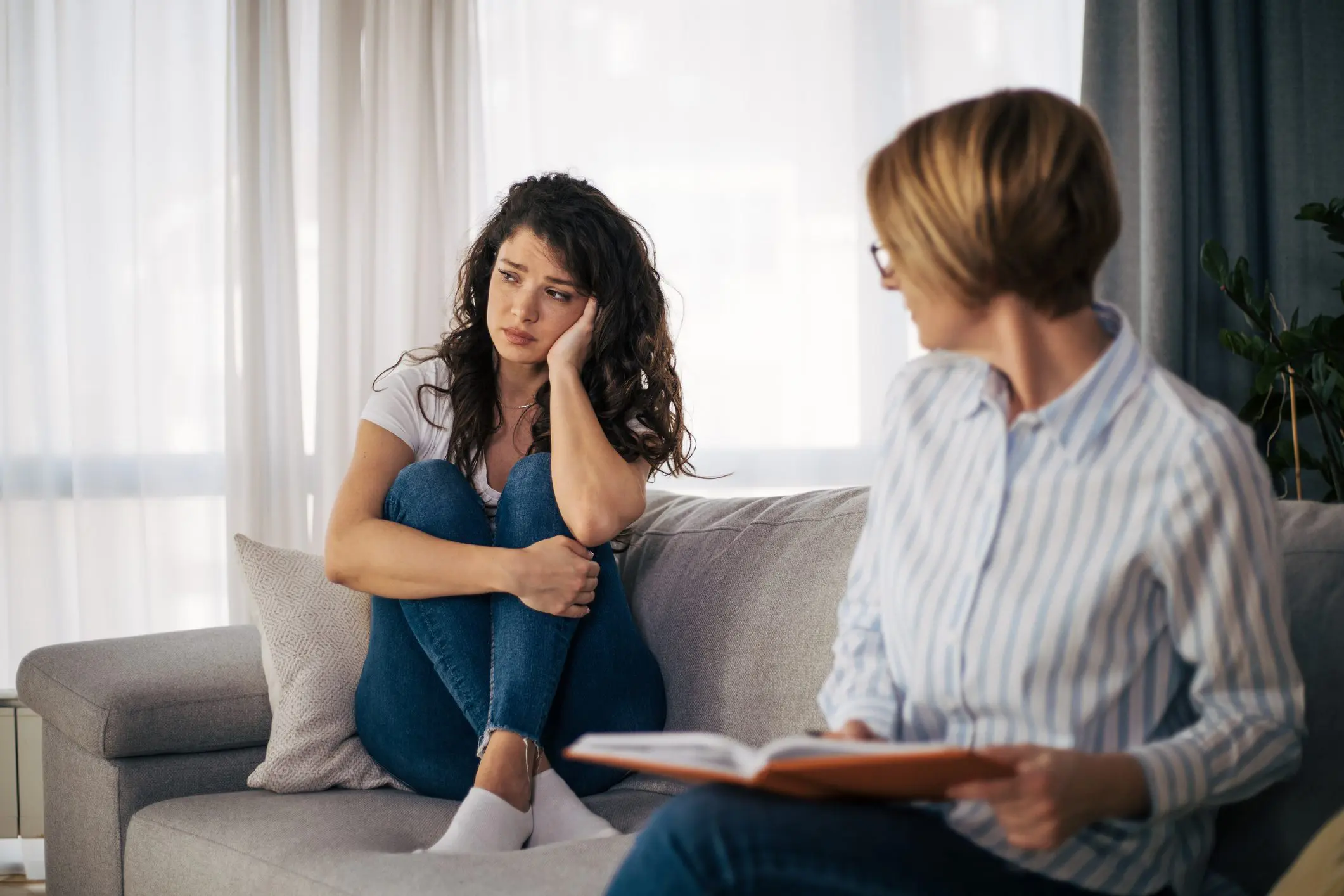 Therapist speaks to a depressed young woman